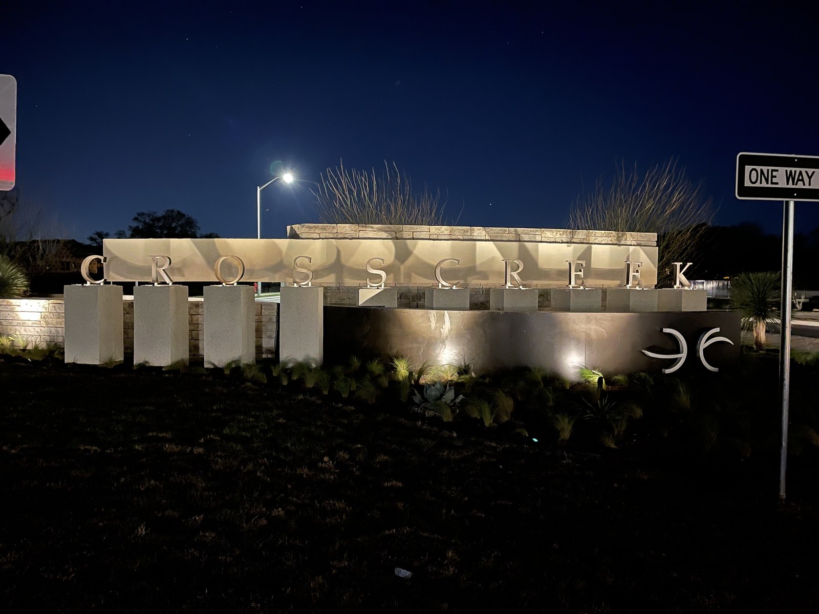 Community entry monument illuminated at night